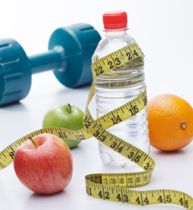 An assortment of healthy items, including apples and dumbbells, arranged on a clean white background.